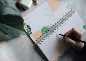 Woman writing something in calendar